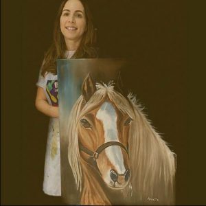 Picture of a student holding her painting of a horse.